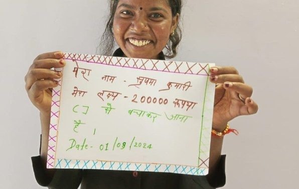 Trainee holding her savings goal
